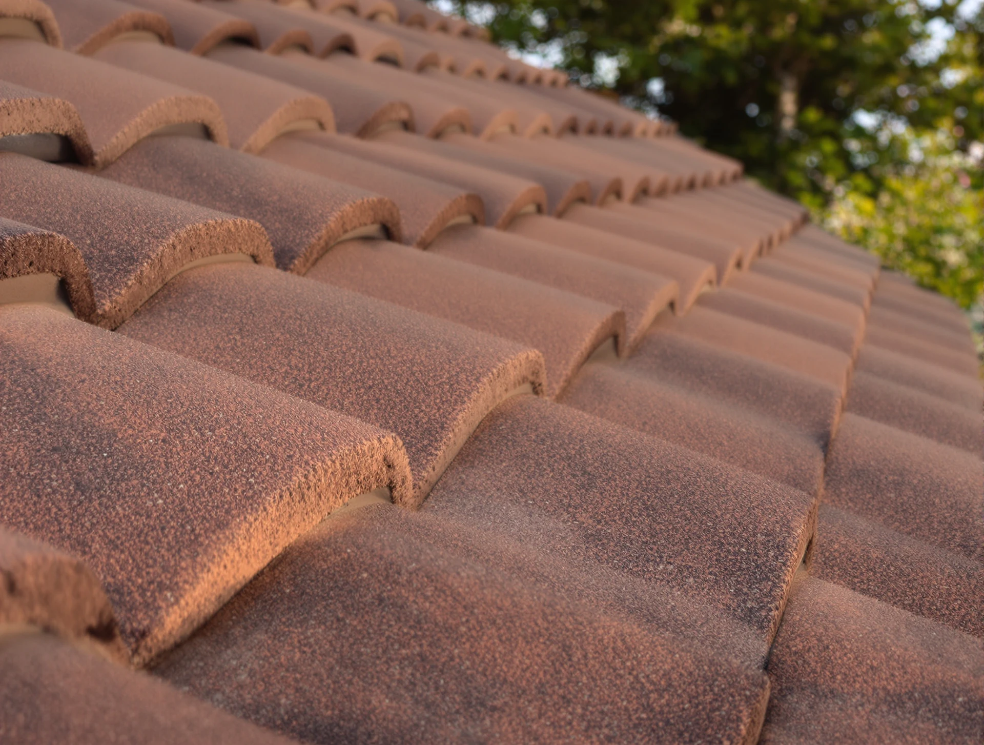 New concrete roof tiles and ridge cap close up